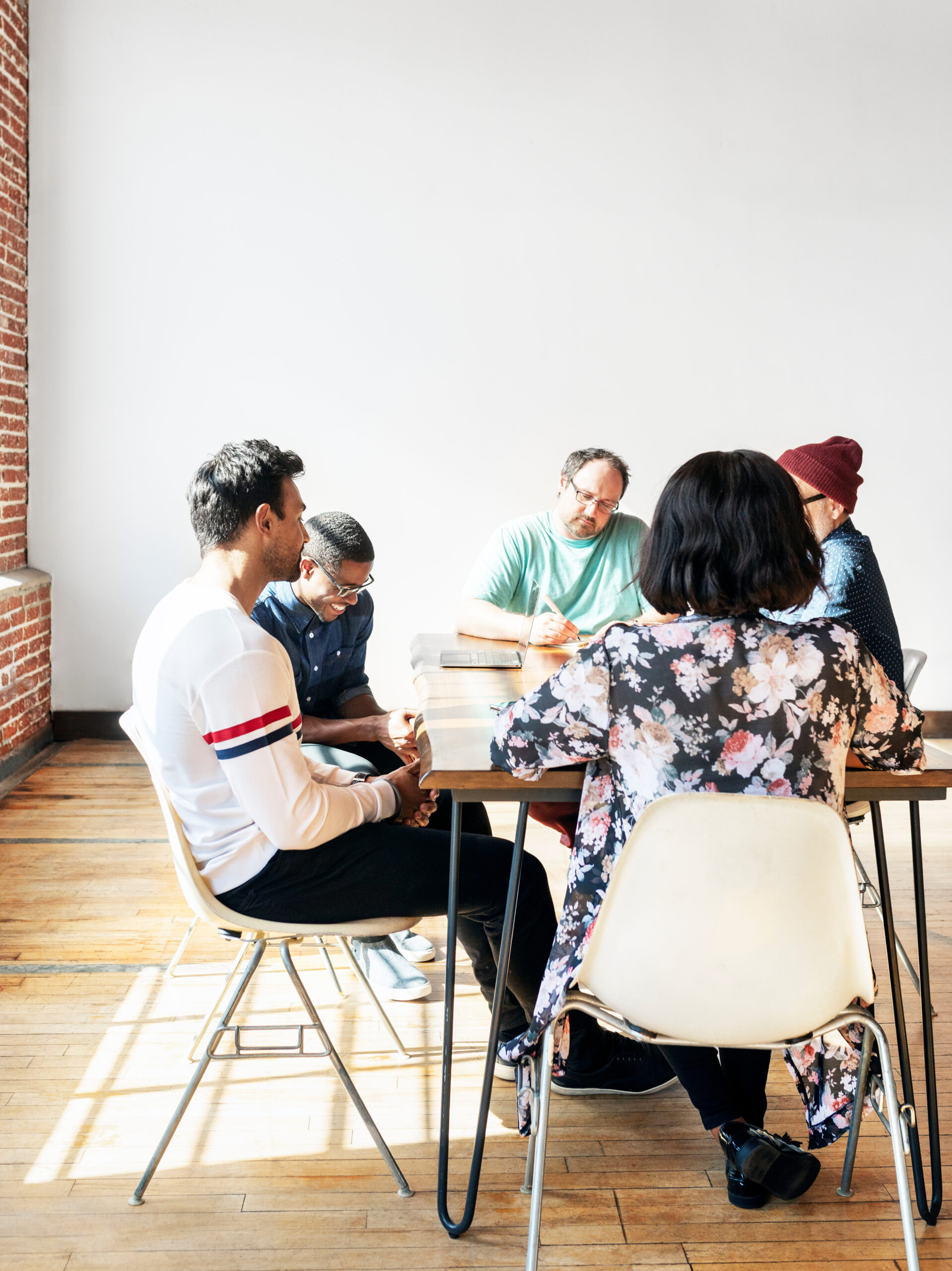 Team members gathered around a table at an office space.